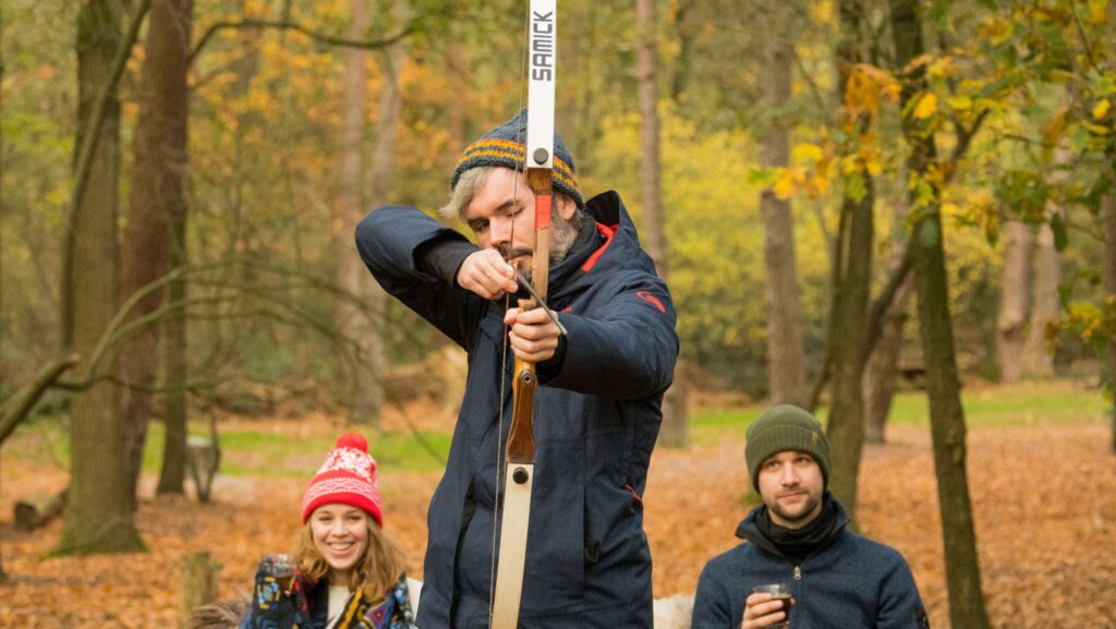 Man schiet met boog in het bos tijdens boogschieten.